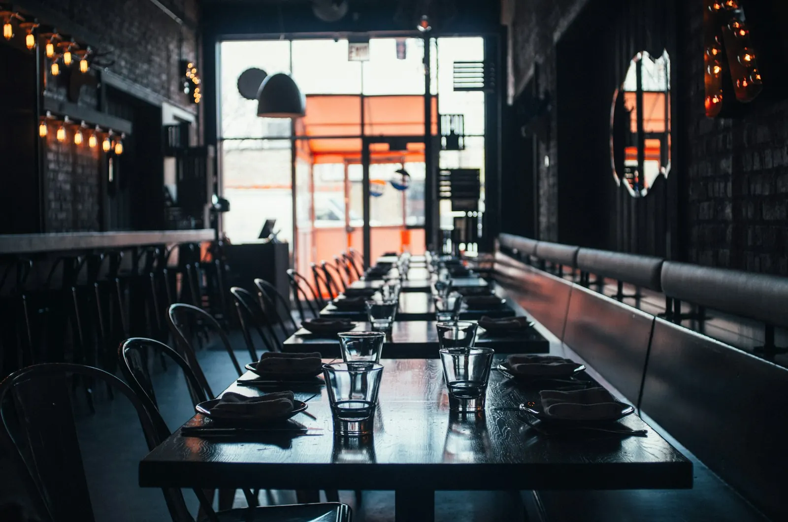 Empty restaurant dining room with tables set and no customers