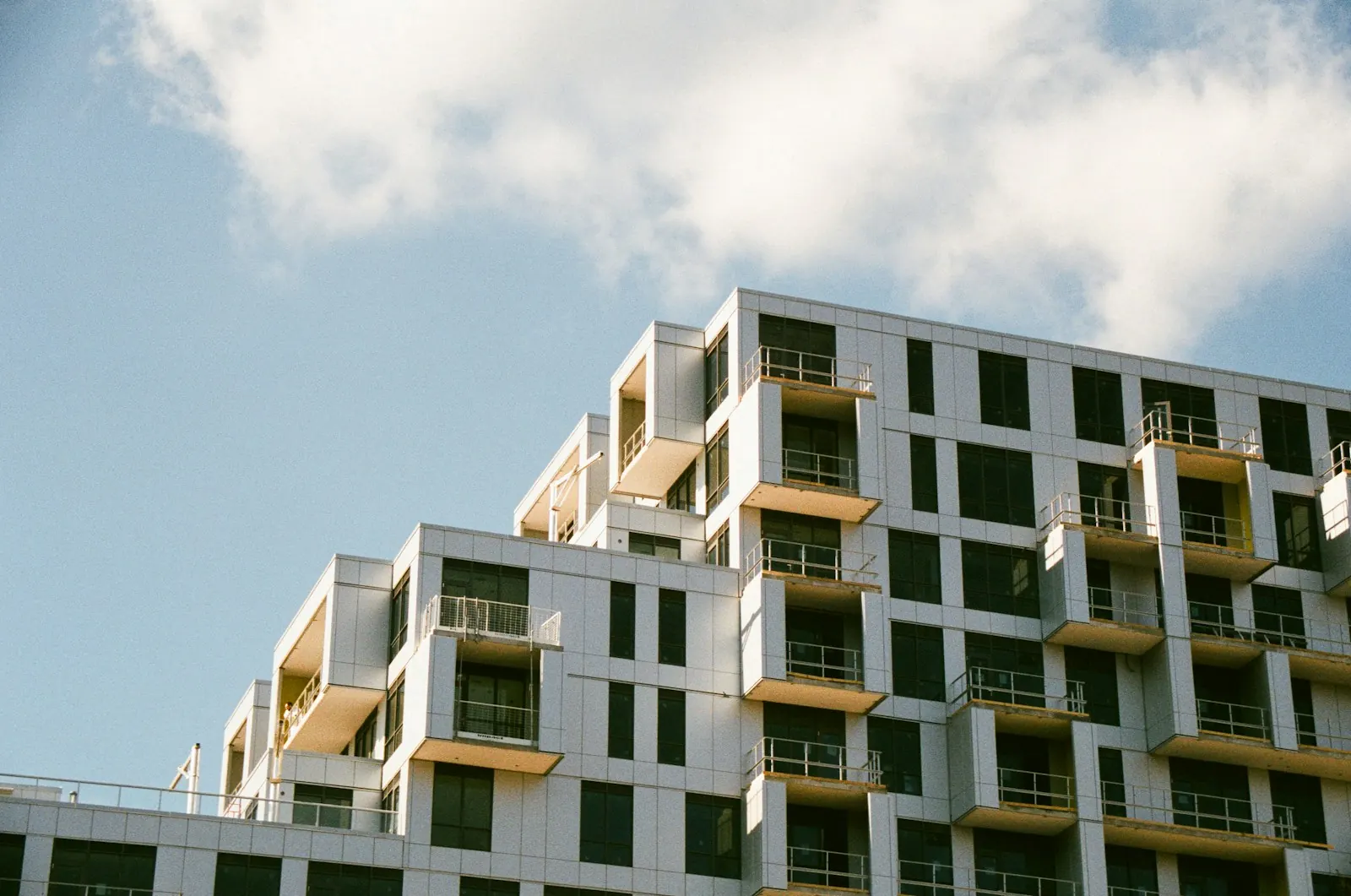 Looking up at a multi-story residential building exterior