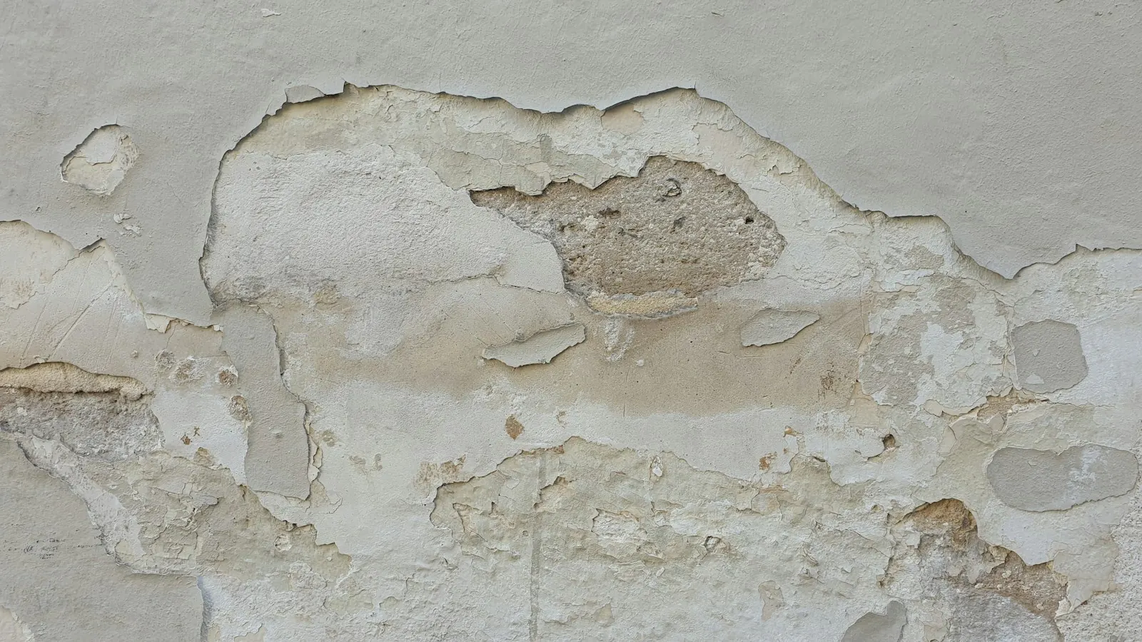 Water-stained ceiling with bubbling, peeling paint and plaster