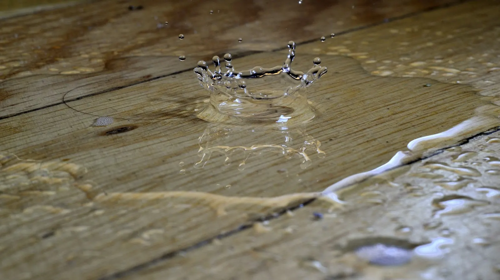Water pooling and splashing on a wood floor