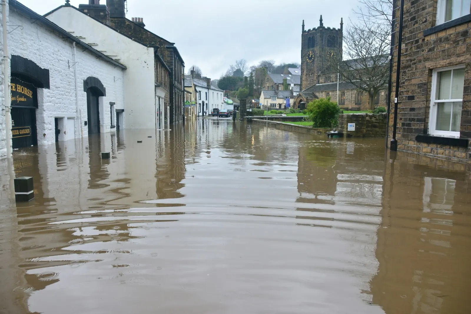 Street of homes under several feet of floodwater